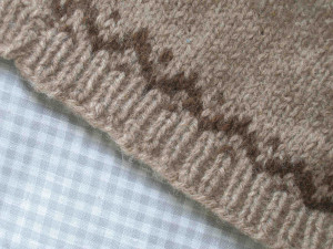 Edge of baby's cardigan, DK. Fawn and moorit Shetland..
